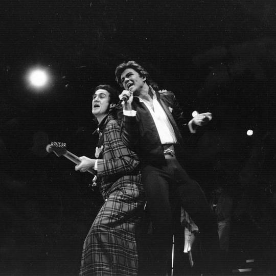 George Michael and Andrew Ridgeley of pop group Wham! during a live performance. Original Publication: People Disc - HL0194 (Photo by Express Newspapers/Getty Images)