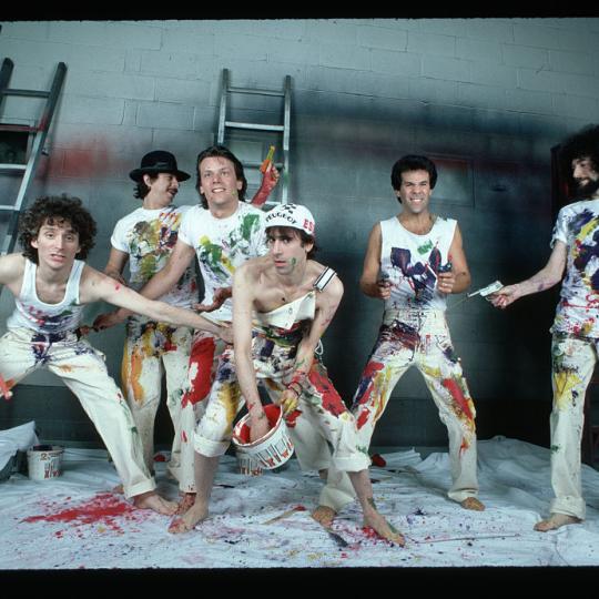 Members of the pop group J. Geils Band play with paint in a warehouse. Singer Peter Wolf is in center, holding a bucket of paint. (Photo by Lynn Goldsmith/Corbis/VCG via Getty Images)