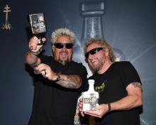 Emmy Award-winning chef and television personality Guy Fieri (L) and Rock & Roll Hall of Fame inductee Sammy Hagar announce their partnership with Los Santo and Santo Puro Mezquila, in addition to the launch of Santo Fino Tequila at Southern Glazer's Wine & Spirits of Nevada on April 4, 2019 in Las Vegas, Nevada. (Photo by Ethan Miller/Getty Images for Los Santos: Santo Puro Mezquila)