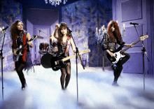  Photo of BANGLES and Vicki PETERSON and Susanna HOFFS and Michelle STEELE; L-R Vicki Peterson, Susanna Hoffs and Michelle Steele performing on a tv show (Photo by  Photo of BANGLES and Vicki PETERSON and Susanna HOFFS and Michelle STEELE; L-R Vicki Peterson, Susanna Hoffs and Michelle Steele performing on a tv show (Photo by Bernd Muller/Redferns)